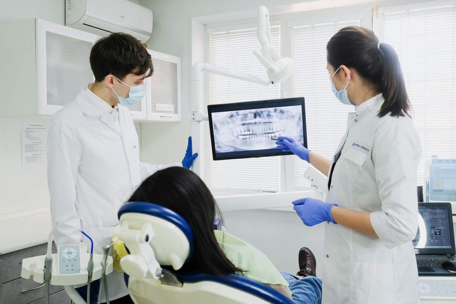Two dentists reviewing a scan on a screen in the clinic