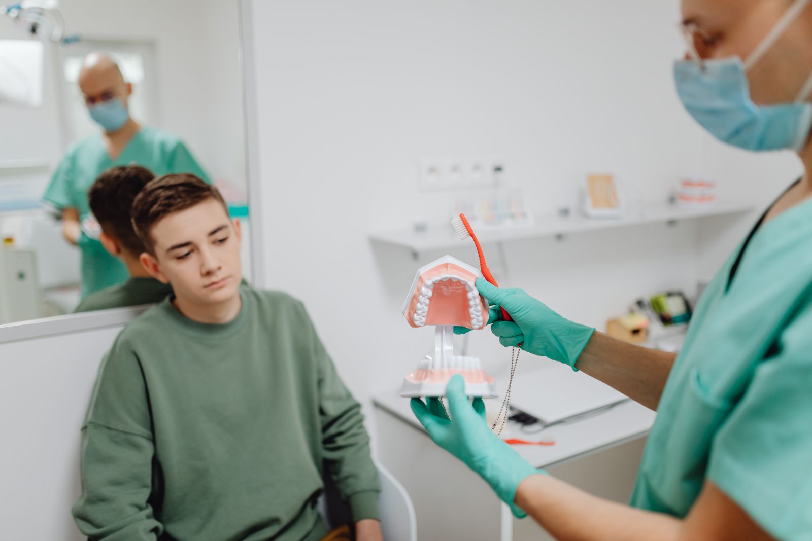 Teenage patient talking with the dentist about braces