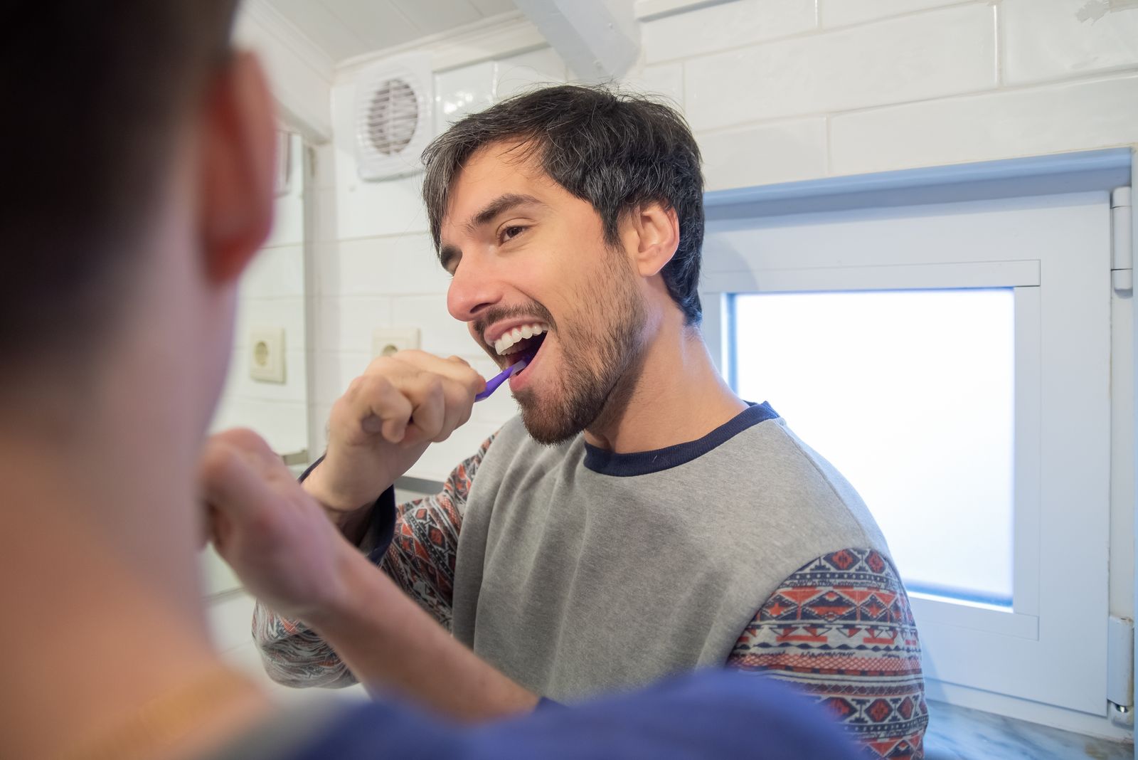 Dentist checking a patient's teeth during a cleaning appointment
