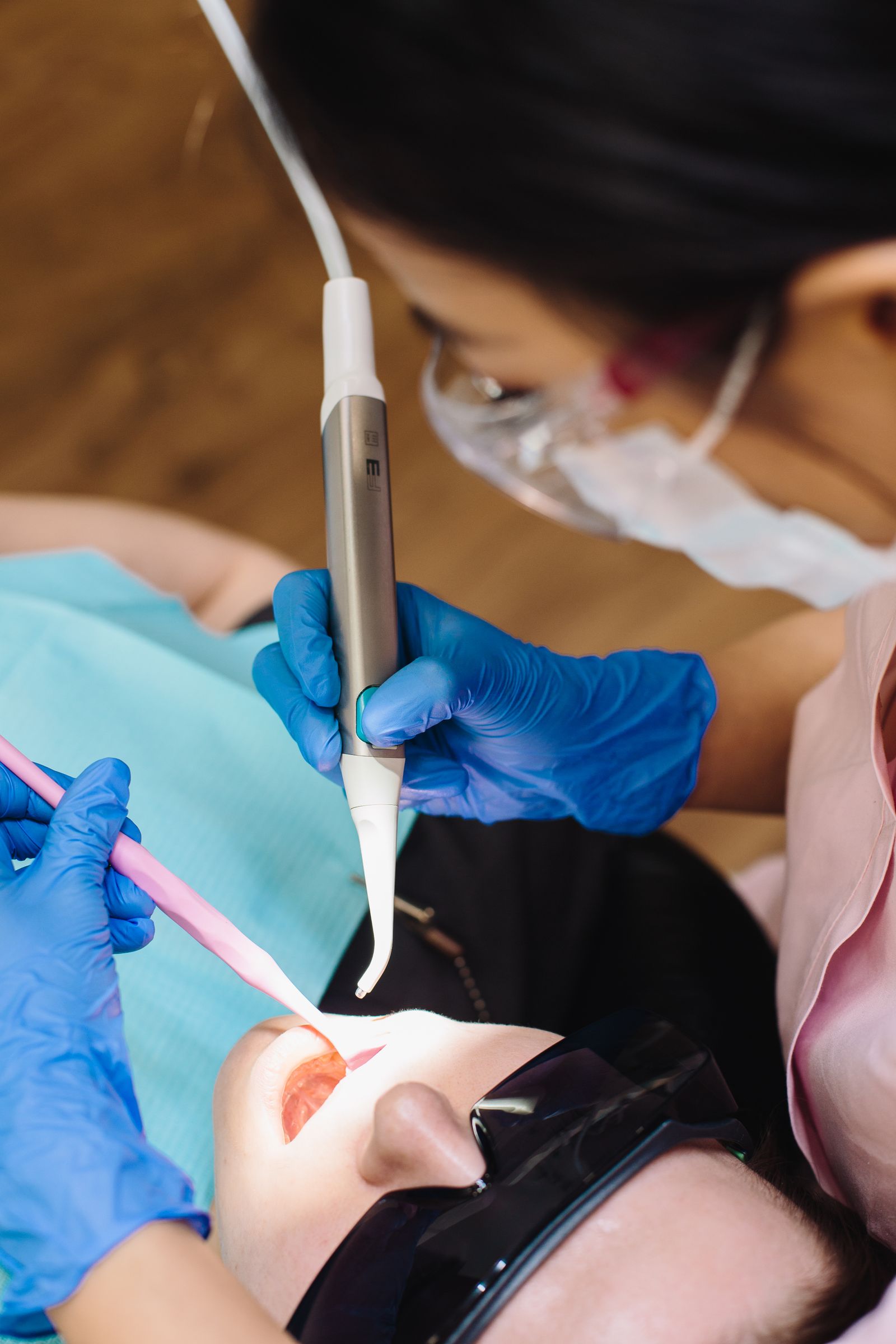 Close-up of a dentist fitting a veneer