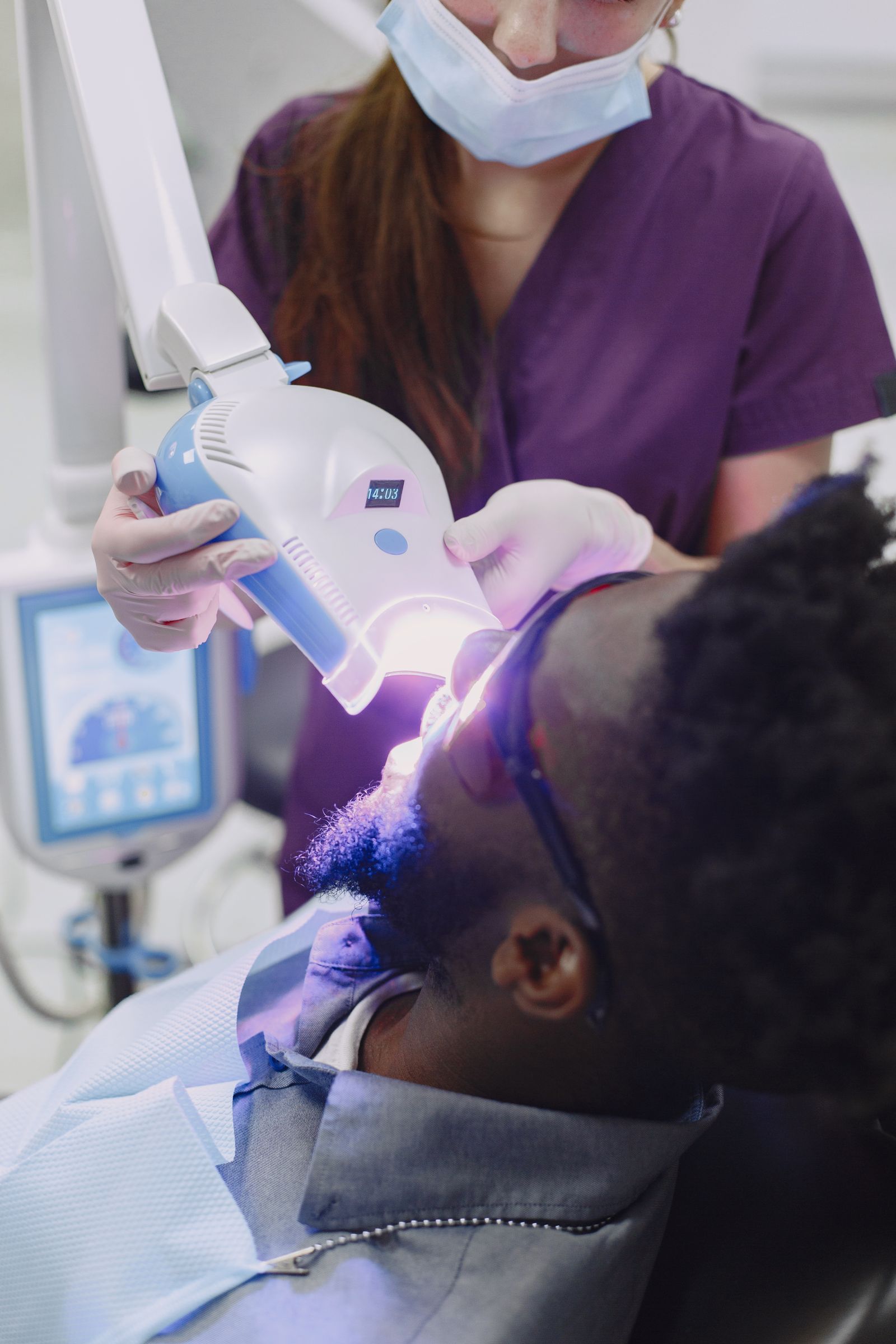 Dentist and assistant preparing a patient for treatment